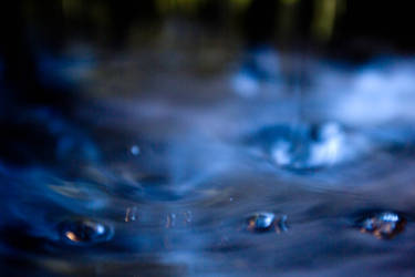 Blue water drops floating on the water.