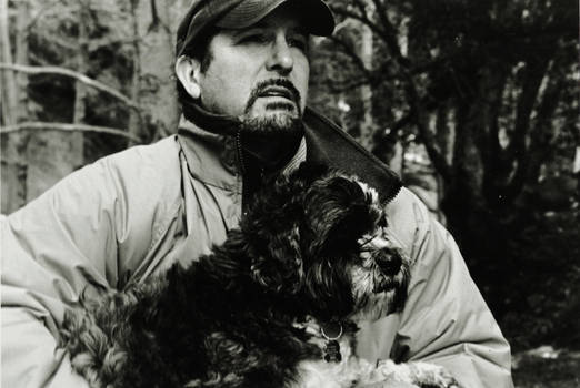 A man with a dog in the forest.