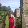 Girl in Red Dress pushing gate