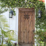 00076 - Bolted Wooden Door with Lanterns and Vines