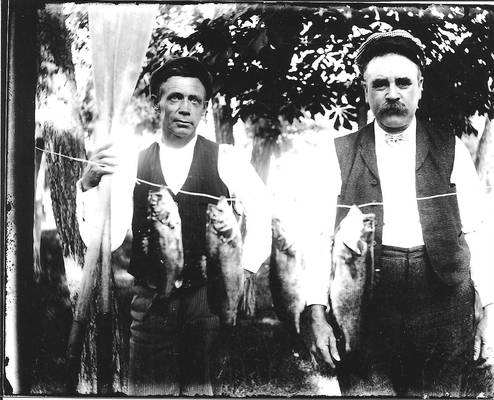 Two fisherman and catch from glass plate negative