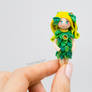 Green Leaf Fairy, holding figurine in hand