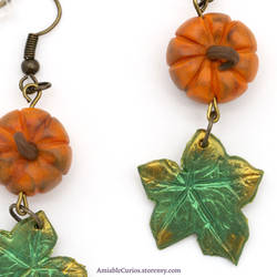 Close up of pumpkin and leaf earring