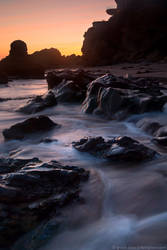 A wave sweeping over the rocks