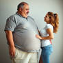 A fat, obese, middle-aged man grabs his skinny wif