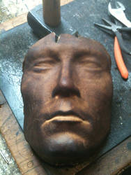 Leather mask of a bust.