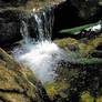 A small mountain stream and waterfall.