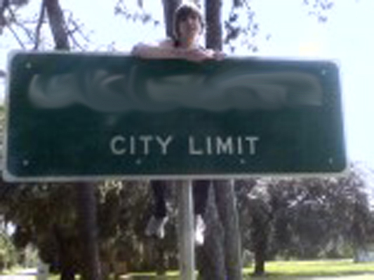 On top of City Limit sign 1