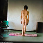 standing male nude, back