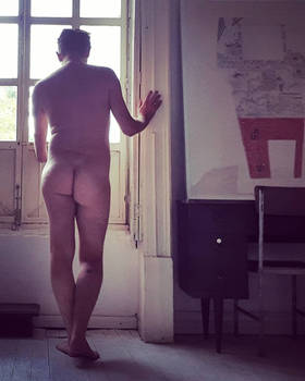 standing back male nude bedroom window