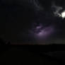 A tiny spark and moonlit clouds.