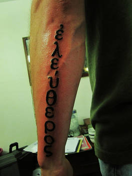 Greek text tattoo 'Freedom'