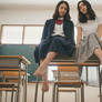POV barefoot Asian sat on desk