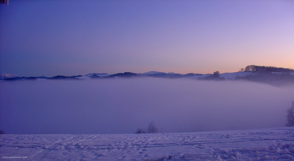 Winter sunset above the clouds