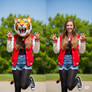 girl wearing a tiger mascot head