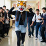 girl wearing a tiger mascot head