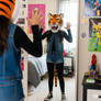 girl wears a tiger mascot head