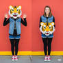 girl wearing a tiger mascot head