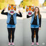 girl wearing a tiger mascot head
