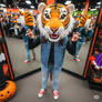 girl wearing a tiger mascot head