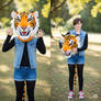 girl wearing a tiger mascot head