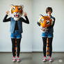 girl wearing a tiger mascot head