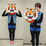 girl wearing a tiger mascot head