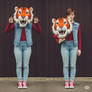 girl wearing a tiger mascot head