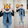 girl wearing a tiger mascot head
