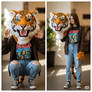 girl wearing a tiger mascot head
