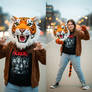 girl wearing a tiger mascot head