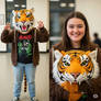 girl wearing a tiger mascot head