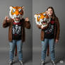 girl wearing a tiger mascot head