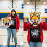 girl wearing a tiger mascot head