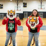 girl wearing a tiger mascot head