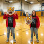 girl wearing a tiger mascot head