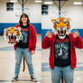 girl wearing a tiger mascot head