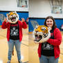 girl wearing a tiger mascot head