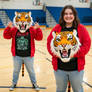 girl wearing a tiger mascot head