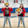 girl wearing a tiger mascot head