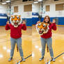 girl wearing a tiger mascot head