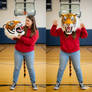 girl wearing a tiger mascot head