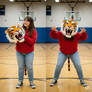 girl wearing a tiger mascot head