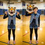 girl wearing a tiger mascot head