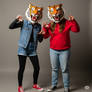 two girls wearing tiger mascot heads