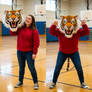 girl wearing a tiger mascot head