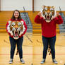 girl wearing a tiger mascot head
