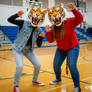 two girls wearing tiger mascot heads