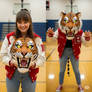 girl wearing a tiger mascot head