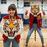 girl wearing a tiger mascot head